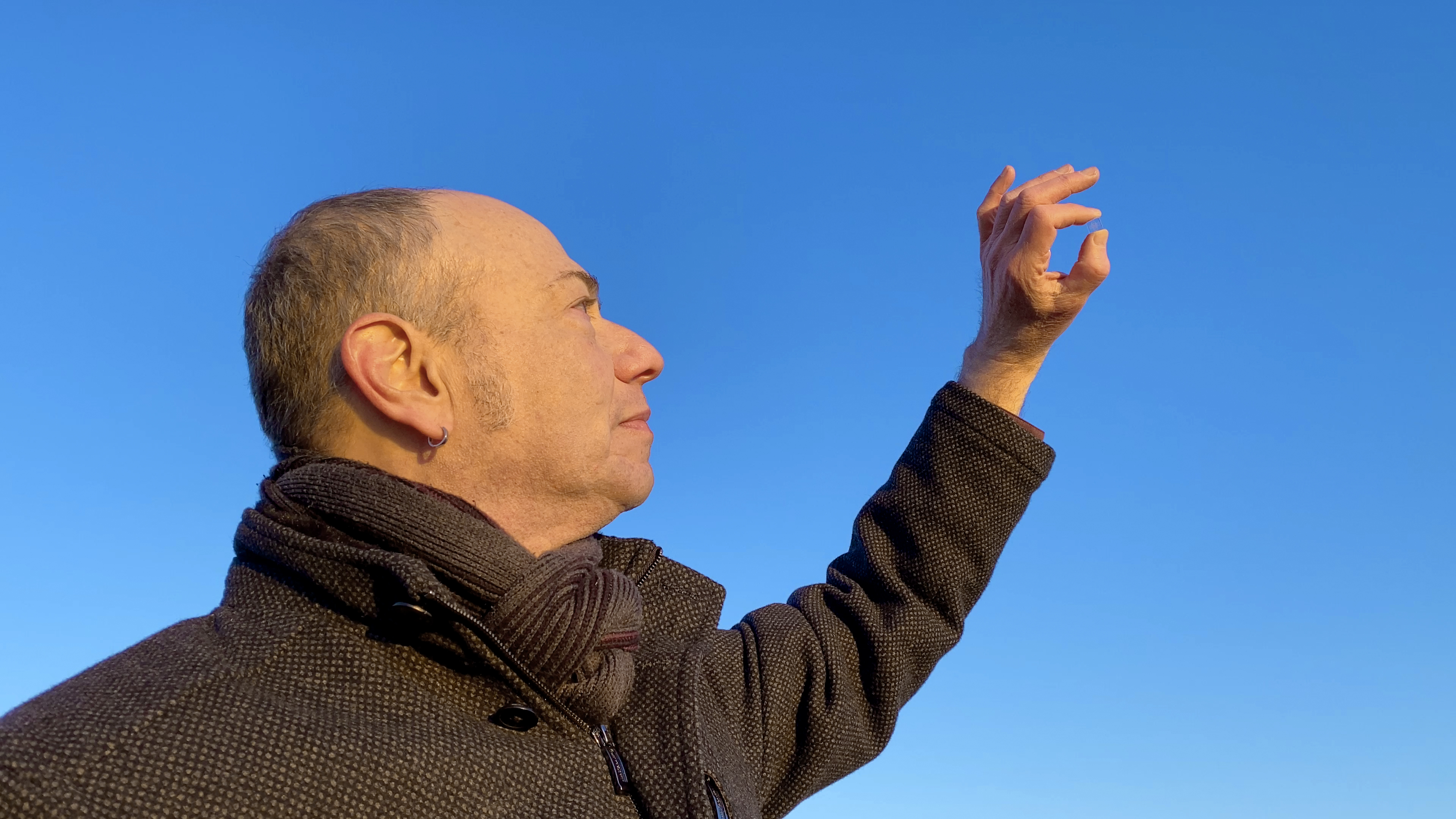 Eduardo Kac holds Adsum against the sky before the Northrop Grumman's Antares230+ rocket flew to the ISS on Saturday, Feb. 19, 2022, from NASA's Spaceport’s at Wallops Island, Virginia.