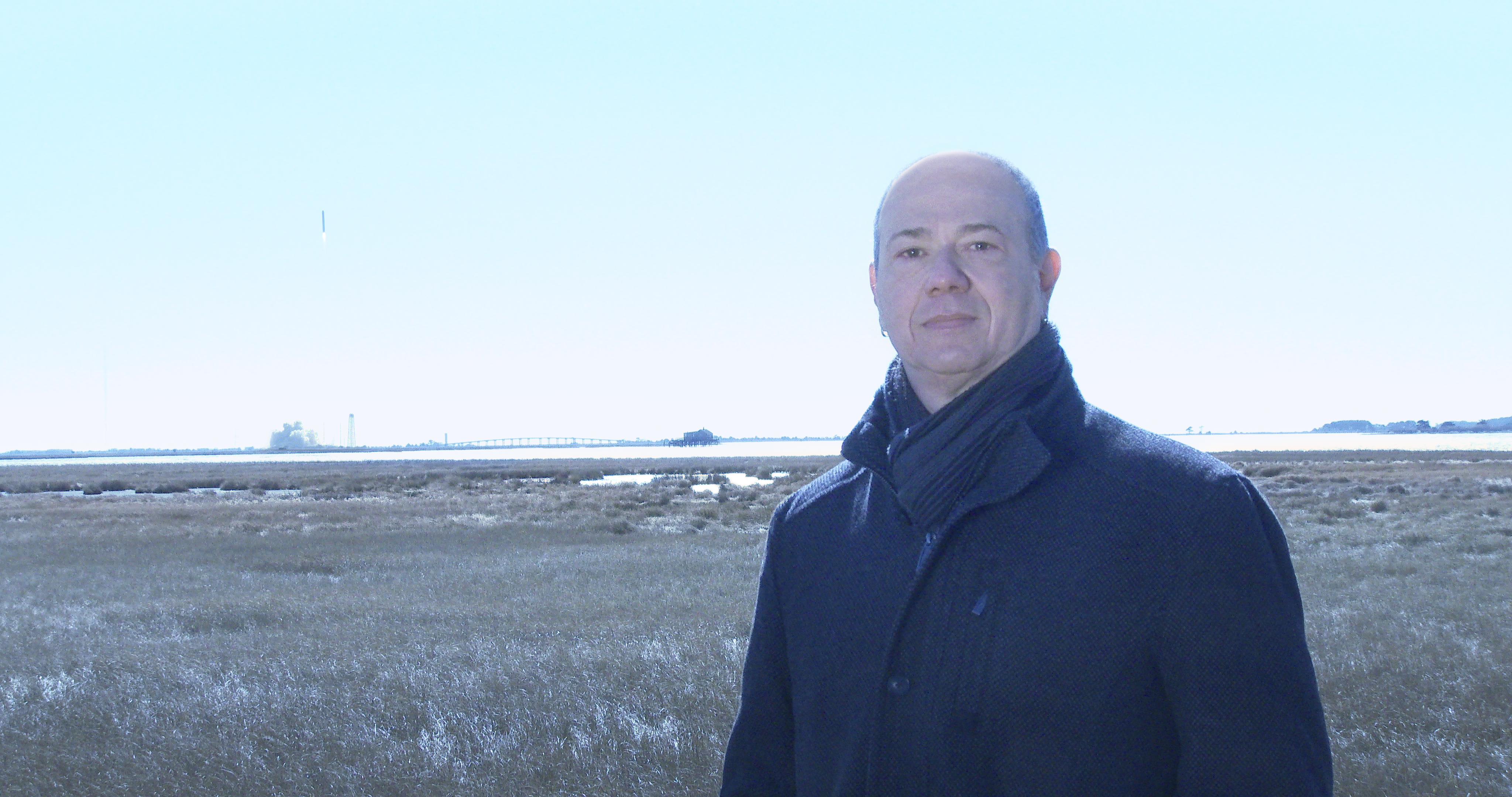 Eduardo Kac with Northrop Grumman's Antares230+ rocket (to the left, in the sky)